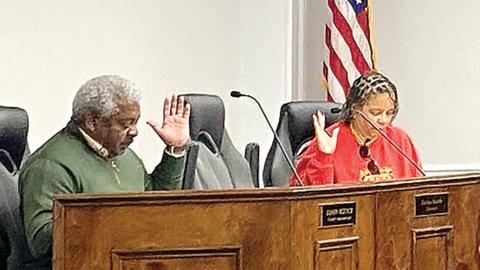 Board of Assessors Chairman Tim Andrews raises his hand to vote during the Dec. 5 meeting. 