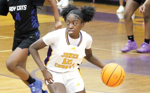 Mya Anderson weaves through traffic against Locust Grove. BRAD HARRISON/Staff