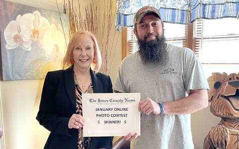 Stephen Drawhorn receives his gift card from Revenue Supervisor Amy Scott.