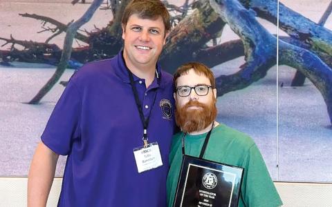 Investigator Clay Wiggins (right) and Ocmulgee Circuit District Attorney Wright Barksdale after the award was announced. CONTRIBUTED