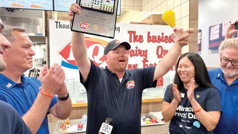 Dairy Queen owner Justin Kelly immediately shares awards he received from President and CEO of DQ International Troy Bader (left) and Children Miracle Network CFO Frances Fu with community partners. 