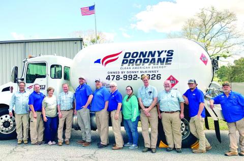 Donny’s Propane employees gather around one of the propane trucks for a photo at the company. ADAM SEGERS/Contributed