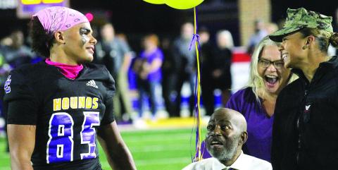 Corey Williams, left, reacts during Friday’s senior night festivities to the surprise appearance by his sister, Jaida Williams, currently serving in the United States military. BRAD HARRISON/Staff