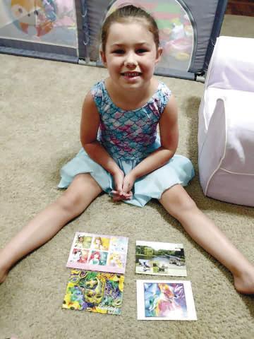Fischer with a few of the colorful postcards she has received in the mail from people across the states.