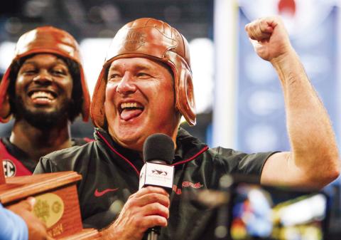 Georgia head coach Kirby Smart celebrates with his players following a 34-3 win over Clemson. LANCE McCURLEY/Staff