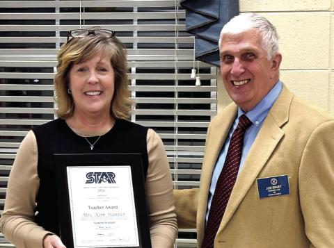 Star Teacher KIm Hanner receives her award from Briley. DEBBIE LURIE-SMITH/Staff