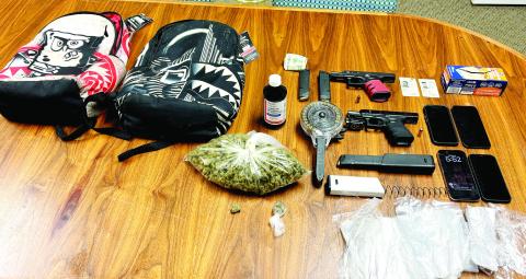 Evidence seized in the March 11 arrests include a large bag of suspected marijuana, firearms and ammo. CONTRIBUTED