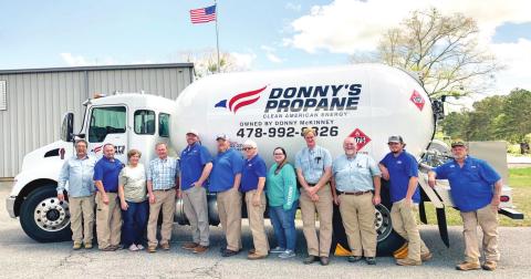 Donny’s Propane employees gather around one of the propane trucks for a photo at the company. ADAM SEGERS/Contributed