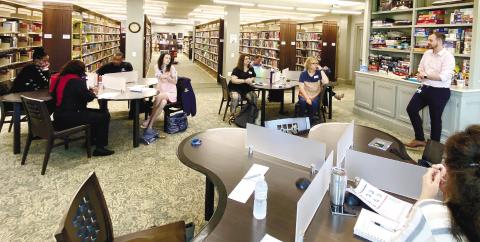 Brandon Warrick with Augusta University (right) leads the March 28 meeting of the Jones County Suicide Prevention Coalition meeting held at the Jones County Library. DEBBIE LURIE-SMITH/Staff