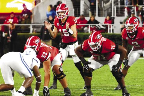 Carson Beck (15) ready to receive a snap in the first quarter of the Kentucky game. Beck threw for over 300 yards in the first half alone. BRENDAN KOERNER/Staff