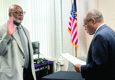 Clinton Burston receives his oath of office for interim JCSS Superintendent from Judge Lewis Patterson. DEBBIE LURIE-SMITH/Staff
