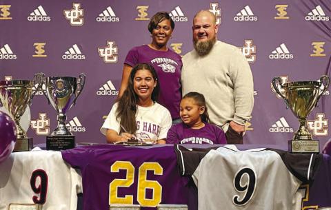 At an event that also included teammates and coaches, Shayla Pennington is flanked by her family as she signs a letter-of-intent to play softball at Young Harris College. BRAD HARRISON/Staff
