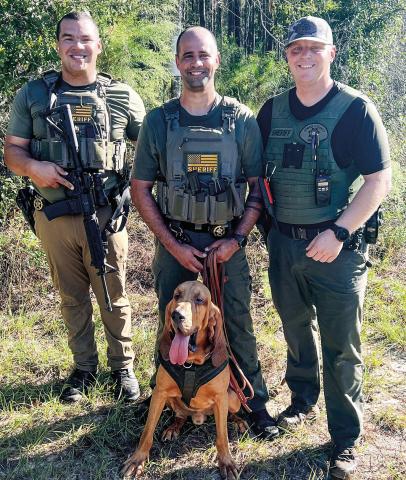 Jones County Sheriff’s Office Lt. Wesley Ransom (l-r), Deputy Dan Ribeiro and Sgt. Kasey Carr with K9 deputy Jones following the successful tracking and apprehension of the suspect. CONTRIBUTED