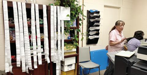 Tally ribbons from the precincts are hung to show totals as the votes are tabulated at the elections office under the oversight of Election Superintendent Marion Hatton. DEBBIE LURIE-SMITH/Staff