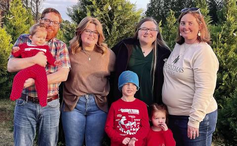 Wiggins holds Hannah with (from left) Emma, Micah and Heather; in front are Warren and Everly, photographed in November 2024. CONTRIBUTED