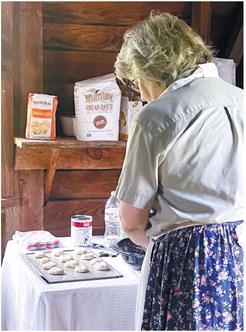 The wood stove cook at Jarrell Plantation cooking up some food during the Ole’ Time Fourth event.