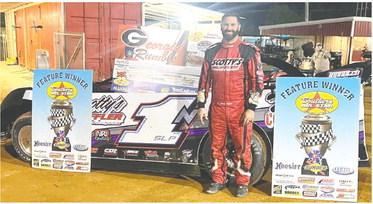 Jordy Nipper poses after taking the checkered flag on Saturday night at Cochran Motor Speedway in the Southern All Star Dirt Racing Series Georgia Rumble. SOUTHERN DIRT ALL STAR RACING SERIES