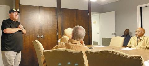 Dairy Queen owner and manager Justin Kelly (left) speaks at Gray City Council’s All Committees meeting Dec. 16. DEBBIE LURIE-SMITH/Staff