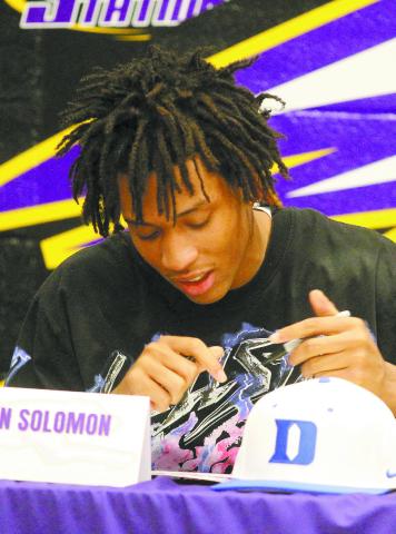 Jaivon Solomon puts the pen to paper as he signs with Duke. BRAD HARRISON/Staff