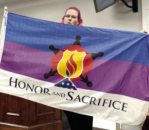 Emma Warren displays the “Honor and Remember” and “Honor and Sacrifice” flags with a request they be purchased and flown in Jones County. DEBBIE LURIE-SMITH/Staff