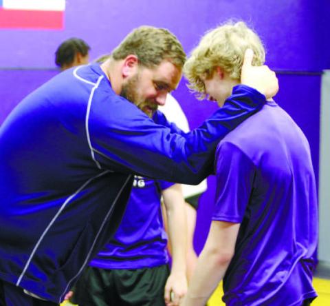 Grehyhounds head coach Adam Gillhouse, left, gives instructions during a preseason practice. BRAD HARRISON/Staff