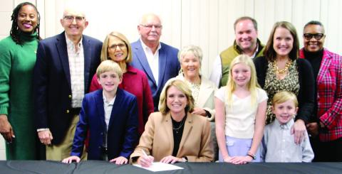 Dr. Jessica Graves (seated, center) surrounded by family and friends attending the Dec. 1 swearing-in ceremony. CONTRIBUTED