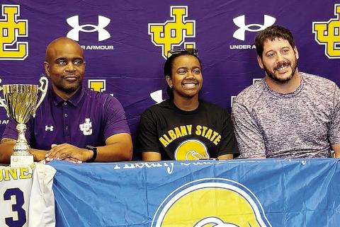 Autumn Coleman, center, smiles during last week’s ceremony in which she signed with Albany State. CONTRIBUTED