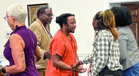Jeremy Butts (center) speaks with sister Cierra Butts (checkered jacket) following his Sept. 12 sentencing. DEBBIE LURIE-SMITH/ Staff