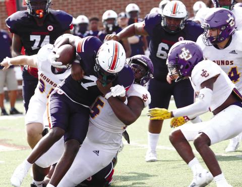 The Greyhounds cash in early to register a tackle behind the line of scrimmage against Northside. BRAD HARRISON/Staff