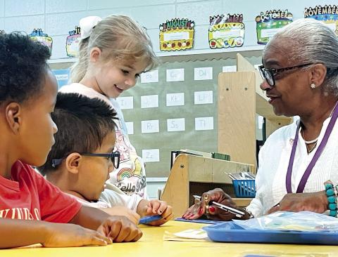 Paraprofessional Ann Pitts works with students. CONTRIBUTED