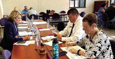 Jones County Superintendent Dr. Jessica Graves (l-r), JCHS Principal Chance Scott and Board Chairman Ginger Bailey work on norms and protocols. DEBBIE LURIE-SMITH/Staff