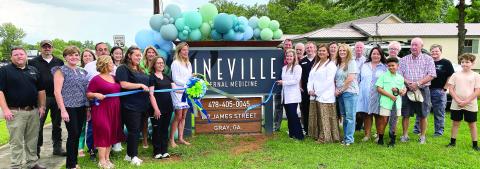 Dr. Mary Bell Vaughn (center) cuts the ribbon at the July 25 ribbon cutting to celebrate the Vineville Internal Medicine office now open in Gray. DEBBIE LURIE-SMITH/Staff