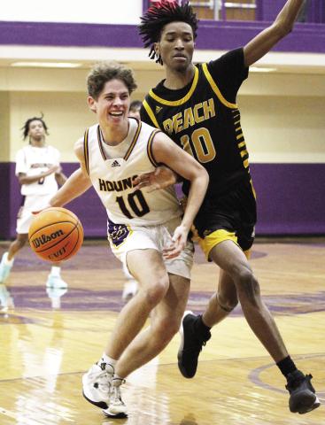 Daniel Wodkins dribbles the ball up the floor last week against Peach County. BRAD HARRISON/Staff