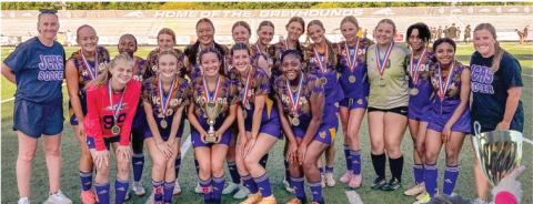 A championship trophy and medals in hand, the Lady Greyhounds proudly celebrate being crown region champs after Thursday’s non-region win against Bleckley County. BRAD HARRISON/Staff