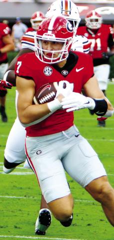Georgia tight end Lawson Luckie hauls in a pass and runs for yards after the catch during a win over Auburn. LANCE McCURLEY/Staff