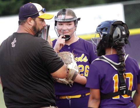 Lady Greyhounds head coach Tripp Burt confers with Ensley Barnes (26) and Myah Briscoe during a game earlier in the season. BRAD HARRISON/Staff