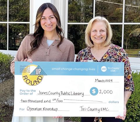 Anna Smith, communications specialist From Tri-County EMC, presents a grant check for $2,000 to Julie King, branch manager of the Jones County Library. King said $1,000 will go to the Jones County Special Olympics Masters Program and $1,000 to help with the library’s Summer Reading Program. CONTRIBUTED