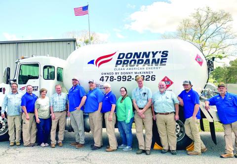 Donny’s Propane employees gather around one of the propane trucks for a photo at the company. ADAM SEGERS/Contributed