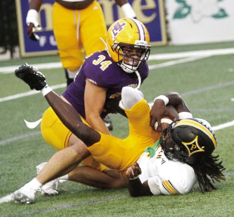 Thad Smith takes the Peach County ball carrier down to the ground in Friday’s game at Greyhound Field. BRAD HARRISON/ Staff