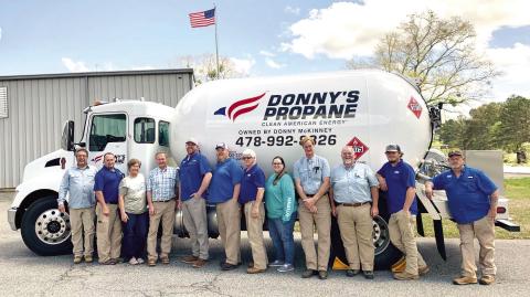 Donny’s Propane employees gather around one of the propane trucks for a photo at the company.  ADAM SEGERS/Contributed