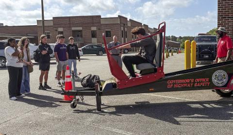 Jones County High School students take turns on the Seatbelt Convincer April 3, set up at the school by the Governor’s Office of Highway Safety in coordination of a grant received by the Gray Police Department. DEBBIE LURIE-SMITH/Staff