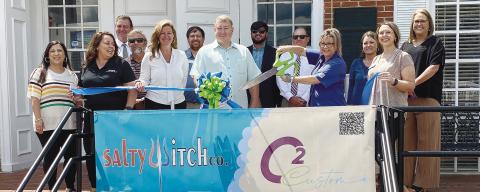 Jennifer Corbin-Carson, the owner of C2 Custom LLC, handles the scissors at the June 1 ribbon cutting for her engraving and printing business sponsored by the Jones County/ Gray Chamber of Commerce. For information about the company, call 719-684-6970 or visit its Facebook page. DEBBIE LURIESMITH/ Staff