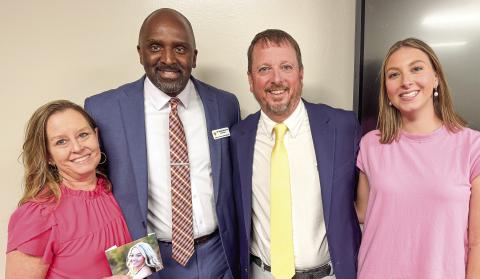 New Jones County athletic director Charles David poses with his family and JCHS principal Dennis Woolfolk following the announcement of his hiring during last week’s board of education meeting. BRAD HARRISON/Staff