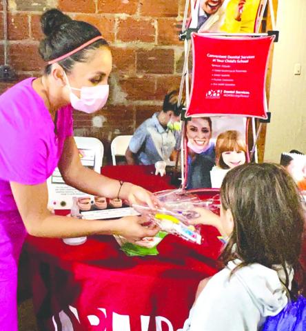 A vendor from the Jones County Health Dept. provides supplies at last year’s Back to School Bash. ALAINA CLARKE/ Staff