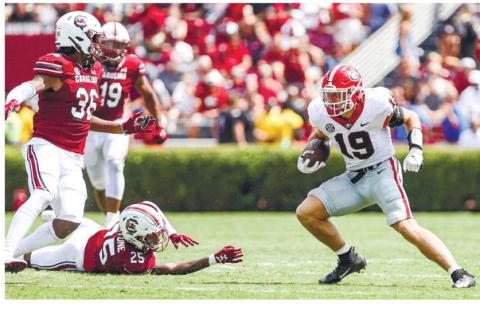 Georgia tight end Brock Bowers evades defenders on a touchdown run against the South Carolina Gamecocks in Columbia, South Carolina, Saturday. Bowers had two receiving touchdowns and one on the ground. ADAM WALSH/UGA Athletics