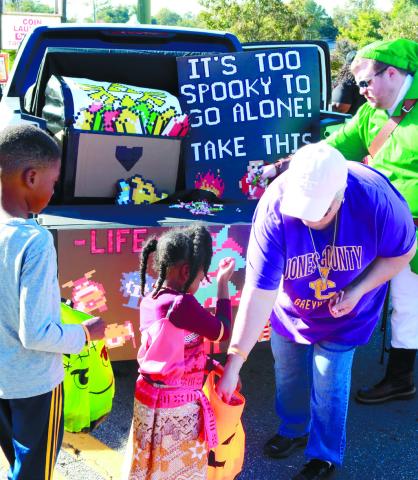 Children at the 2022 Not-So-Scary Grayberry Spectacular receiving candy from one of the trunks. FILE PHOTO