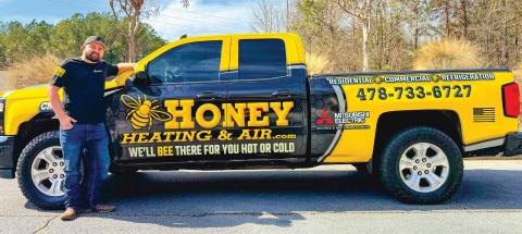 Owner Blake Watson stands in front of his branded Honey Heating &amp; Air truck. DEBBIE LURIE-SMITH/Staff