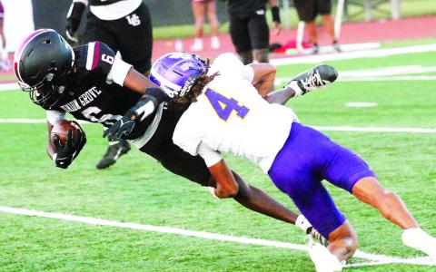 Jayden Johnson flies in to take down a Wolverines ball carrier. BRAD HARRISON/Staff