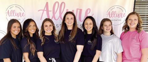 Anndrea Lampkin (center) with her team at Allure Aesthetics in Gray to help serve the community.