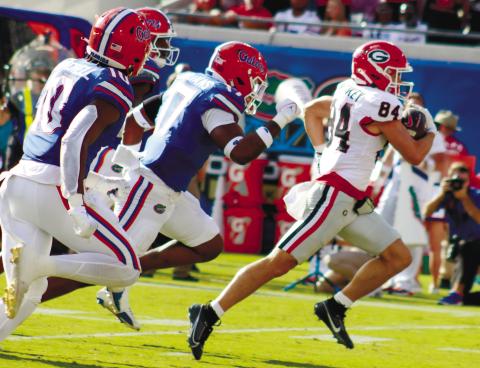 Georgia wide receiver Ladd McConkey (84) runs away from Florida defenders for a 41-yard touchdown. LANCE McCURLEY/Staff